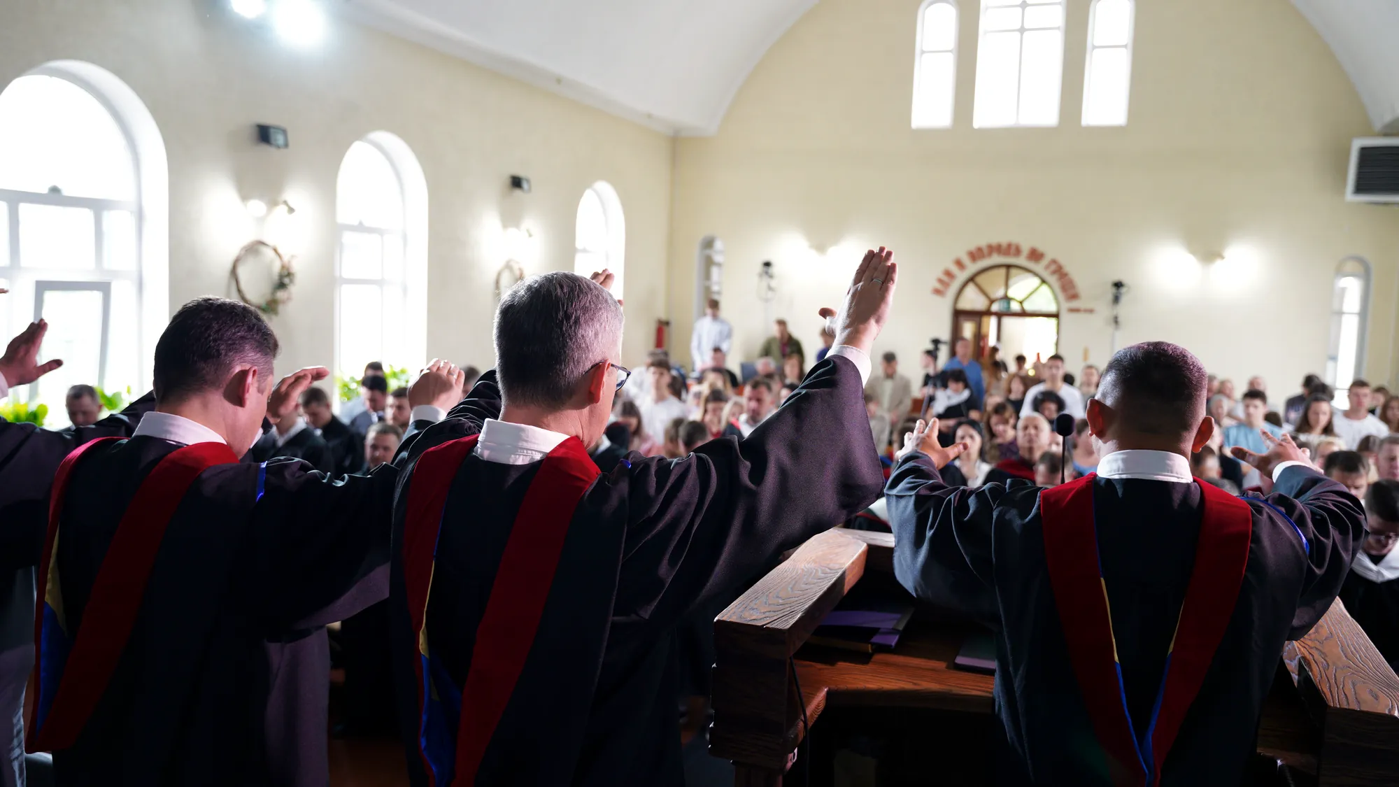 Seminary faculty bless the church at a graduation ceremony